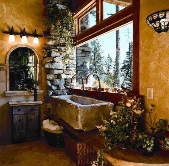 Originally carved from local stone to be a planter, the rectangular bathroom sink also features antique bird handles and uses bent copper tubing for the water spouts. Over the hand-troweled plaster walls, Mary applied yellow-ochre, water-based glaze.